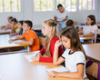 © JackF - Girls sitting at desk in classroom, studying subjects during lesson.