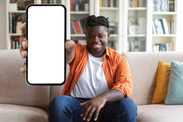 Cool chubby black guy showing phone with empty screen
