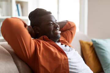 Closeup of young black guy resting at home