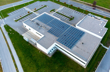 Array of solar panels on the roof of a commercial building top down