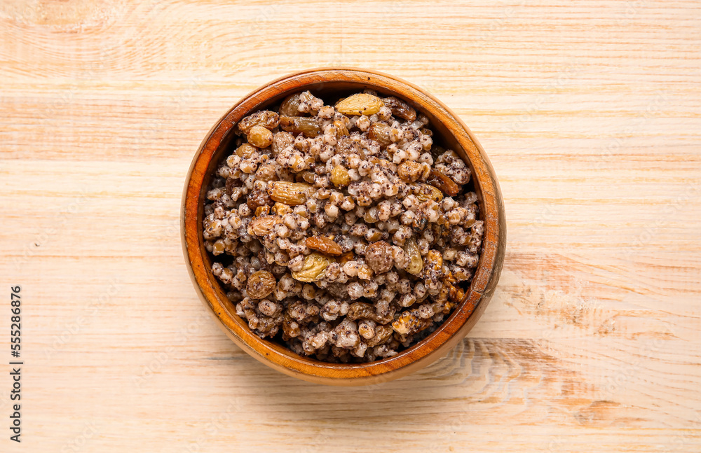 Bowl of Kutya on wooden background