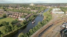 High Aerial Drone Shot Looking Over York City And Suburbs With York Minster York Railway And Big Boat On River Ouse In View On Sunny Evening Near National Railway Museum North Yorkshire United Kingdom
