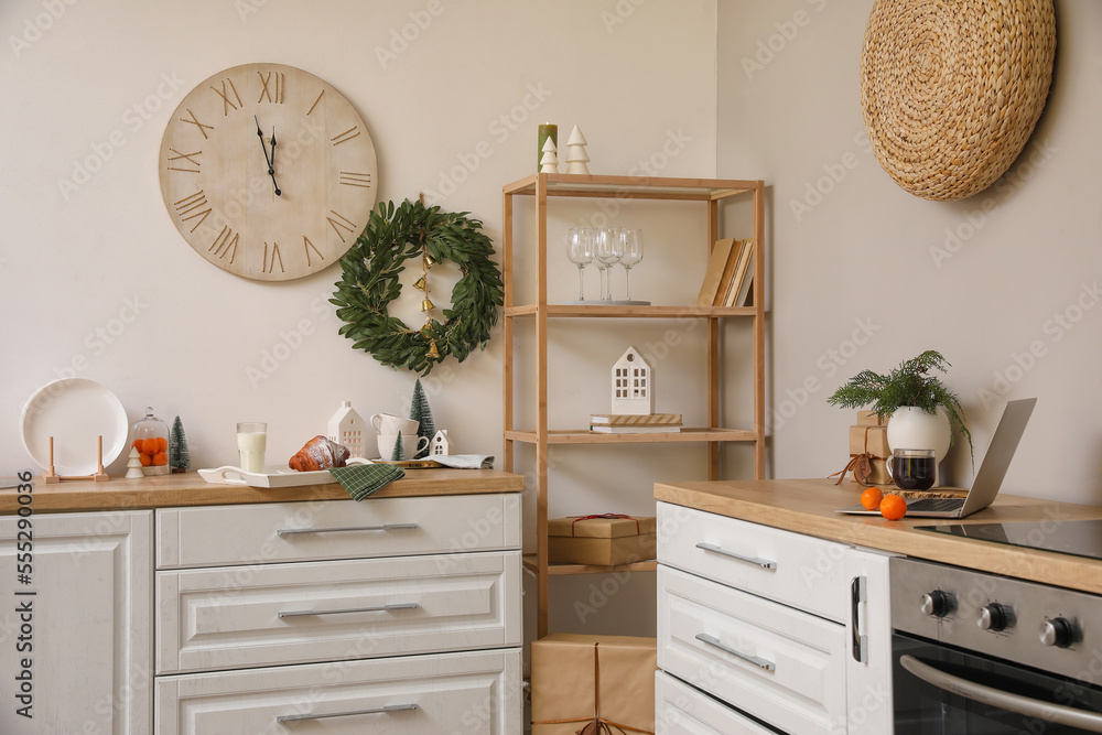 Interior of kitchen with Christmas wreath and big clock