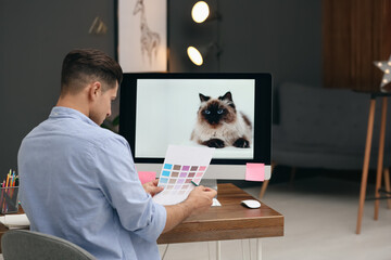 Canvas Print - Male designer working at desk in office