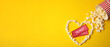 © New Africa - Cinema tickets and heart made of popcorn on yellow background, flat lay with space for text. Banner design