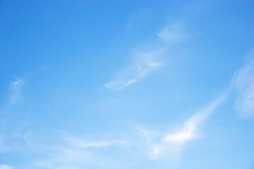 Wall Mural - Blue sky background and white clouds soft focus, and copy space horizontal shape.