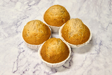 Wall Mural - homemade spelled muffins on white marble