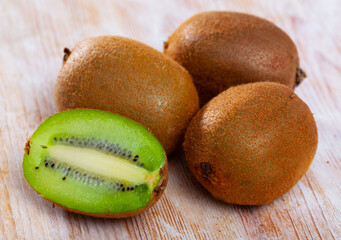 Wall Mural - Ripe kiwi on wooden table. High quality photo