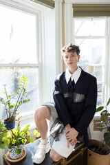 portrait of non-binary caucasian person with short brown hair at home