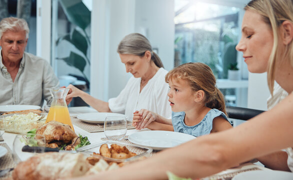 Family, holding hands or praying to God for food with mother, grandparents or girl child ready for dinner meal. Christmas, worship or spiritual Christian people with faith or prayer love eating lunch