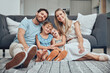© Delcio F/peopleimages.com - Love, family and floor in living room, relax and smile for bonding, relationship or loving. Happy, mother and father with kids, quality time and weekend break with girls, home and parents in lounge