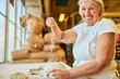 © Robert Kneschke - Experienced happy baker mixes flour into the dough