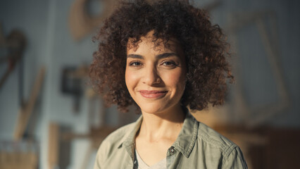 Close Up Portrait of a Beautiful Female Creative Specialist with Curly Hair Smiling. Young Successful Multiethnic Arab Woman Working in Art Studio. Dreaming About Better Life and Opportunities Ahead.