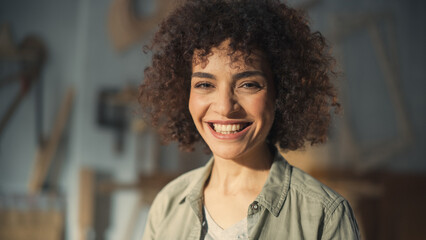 Close Up Portrait of a Multiethnic Brunette with Curly Hair and Brown Eyes. Happy Creative Young Woman Charmingly Smiling and Feeling Joyful. Thinking Up Ideas About Greater Future.