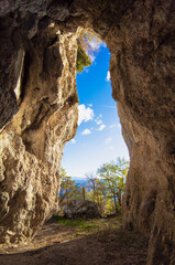 Monte La Serra (Italy) - The peak of Monti del Cicolano beside Rieti and Salto lake, during the autumn foliage, with the hikers and sanctuary cave named Grotta di Santa Filippa.