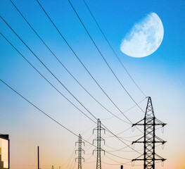 Wall Mural - High voltage electricity power line towers against the sky. Huge moon. Transmission towers