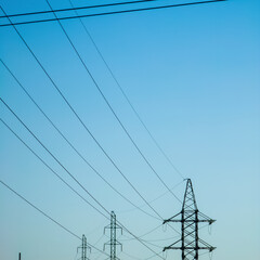 Wall Mural - High voltage electricity power line towers against the sky.  Transmission towers