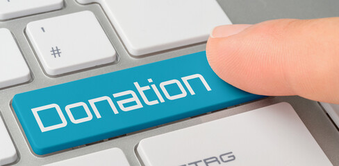 A keyboard with a blue labeled button - Donation