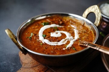 Wall Mural - Dal Makhani | Indian vegetarian black lentil curry served in kadai, selective focus