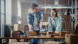 © Gorodenkoff - Two Successful Small Business Owners Working in Warehouse. Talking, Using Laptop Computer, Checking Retail Stock, Preparing Shipment. Sales Specialist and Inventory Manager High Five Each Other.