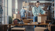 © Gorodenkoff - Small Business Owner Packaging a Stylish Yellow Coat Seat Sold to a Client Online. Preparing a Small Cardboard Box for Postage. Beautiful Female Inventory Manager Working in Warehouse Facility.