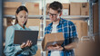 © Gorodenkoff - Young Male and Female Warehouse Inventory Managers Packing Orders for Clients, Using Laptop Computer and Checking Retail Stock. Employee Preparing a Parcel with Stylish Retro Bicycle Seat.