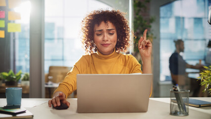 Leinwandbilder - Portrait of an Attractive Arab Female Sitting at a Desk in Creative Agency. Young Stylish Manager with Curly Hair Smiling, Having an Idea Manager Working in Modern Company.