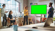 © Gorodenkoff - Positive Businesswoman Leading a Team Meeting in Creative Office Conference Room. Excited Multiethnic Woman Showing Presentation on Green Screen Mock Up Chroma Key Monitor.