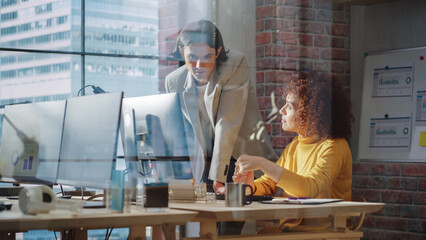 Small Team of Men and Women Working with Analytical Data on Computers in an Agency with Big Window with City View. Multicultural Colleagues Busy Researching and Developing Business Strategy.