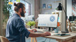 © Gorodenkoff - Stylish Long-Haired Bearded Specialist Sitting at a Desk in Creative Agency. Young Stylish Man Working on Desktop Computer with Trend Analysis Charts and Data Display. Office Team Members at Work
