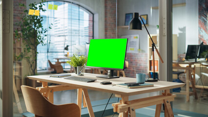 Aufkleber - Establishing Shot: Desktop Computer Monitor with Green Screen Mock Up Chroma Key Display Standing on a Desk in Modern Creative Office. Cozy Agency Space in Loft Building.