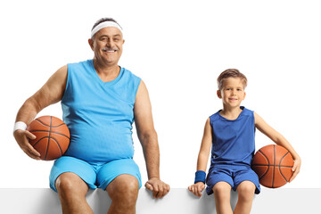 Canvas Print - Mature man and a boy in jersey holding a basketball and sitting on a blank panel