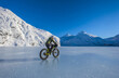 © Designpics - A man riding his fatbike across frozen Portage Lake in mid-winter in South-central Alaska; Alaska, United States of America