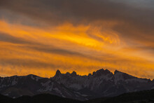 Intense Red Sunset Over A Distant Range Of Sharp Snowy Mountain Peaks; Mendoza, Argentina