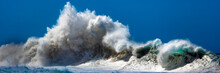 Large Wave Breaking Off The Na Pali Coast Against A Bright, Blue Sky; Kauai, Hawaii, United States Of America