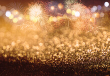 Abstract Gold Glitter Background With Fireworks. Christmas Eve  New Year And 4th Of July Holiday Concept.