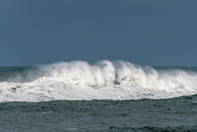 A Wave Crests On A Stormy Winter Morning; Seaside, Oregon, United States Of America