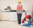 © Designpics - Woman Wearing Safety Vest and Hard Hat Doing the Laundry