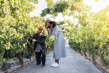 happy young interracial couple on holiday in a vineyard.