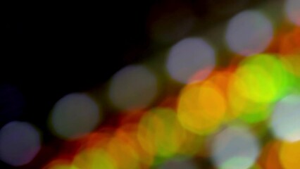 Wall Mural - Diagonal Movement Of Red Round Bokeh. Loop 4K video. Overflow Lines of bright multicolor circles move diagonally the frame. Natural lens flare and light leaks effect of defocused lights.
