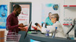 © DC Studio - African american man using mobile nfc payment on pos to pay for medicaments and pills, buying prescription treatment at drugstore desk. Adult at cash register paying for supplements. Tripod shot.