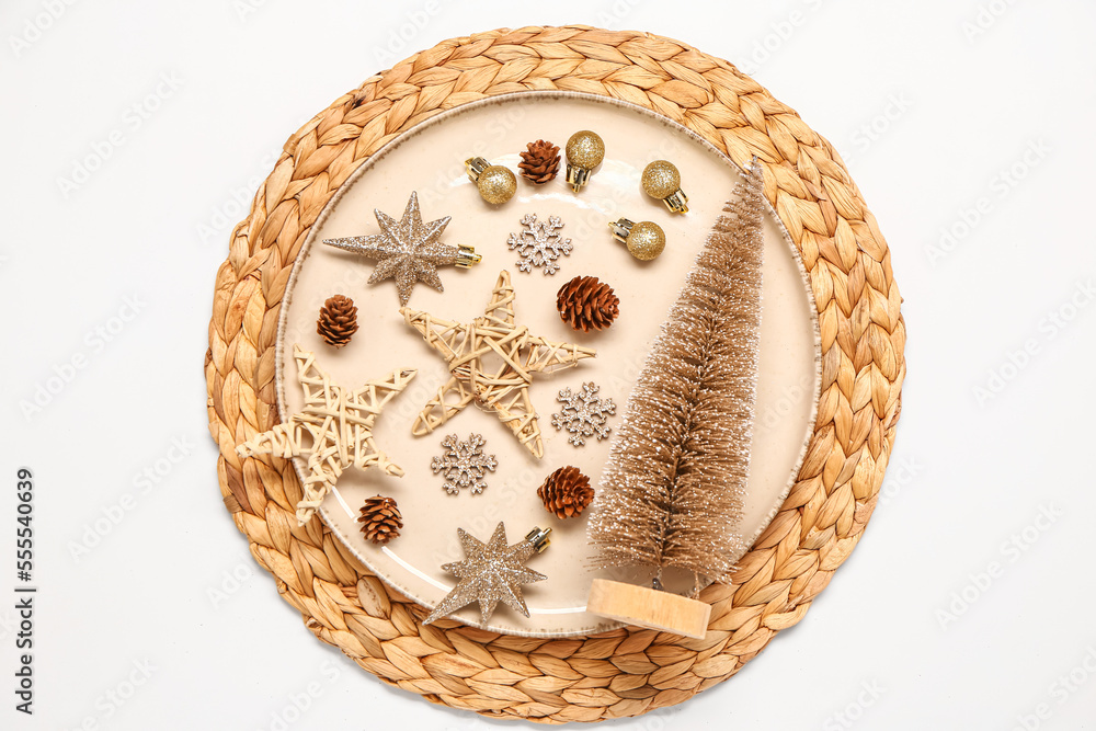 Plate with beautiful Christmas decorations on white background