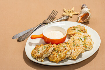 Wall Mural - Hake fillet fried in batter. Sauce, fresh rosemary. Vegetarian healthy food concept