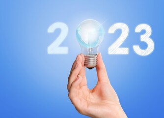 Poster - Numbers 2023 and light bulb in hands