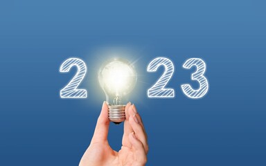 Poster - Numbers 2023 and light bulb in hands