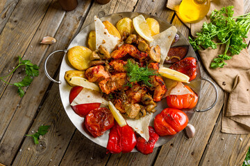 Wall Mural - Saj kebab from sturgeon and grilled vegetables on wooden board top view