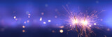 Fototapeta  - Happy New Year background with glowing sparklers.