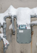 Snow covered natural gas line meter of building or home. High energy consumption in cold temperature.  Outdoor meter measuring the usage number in cubic feet. Vancouver, BC, Canada. Selective focus.