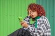 © carballo - afro girl looking at the cell phone or mobile phone in the street
