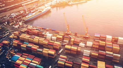 Wall Mural - Containers in cargo freight port, aerial view. Industrial harbor, global transportation and international logistic business concept.